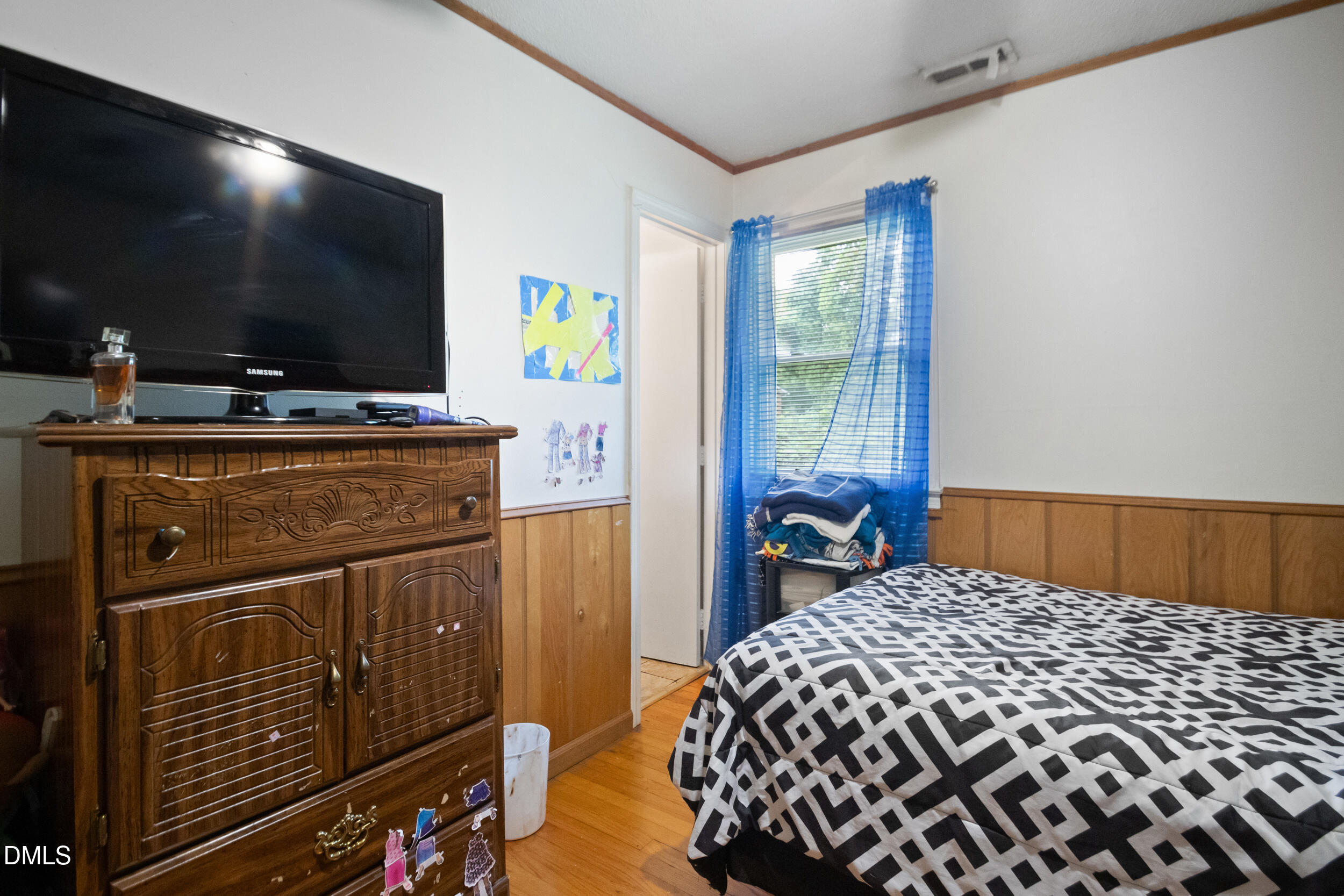 811 Jones Lester Road Roxboro, NC 27574 - Photo 18 of 27 a bedroom with a bed and a flat screen tv
