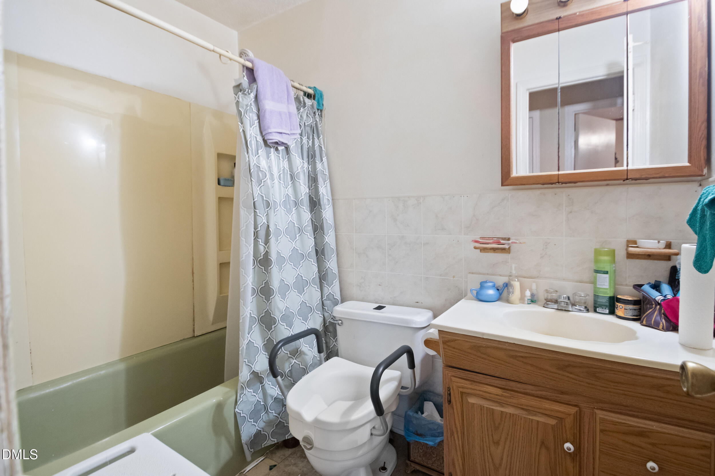 811 Jones Lester Road Roxboro, NC 27574 - Photo 20 of 27 a bathroom with a sink a toilet and shower curtain
