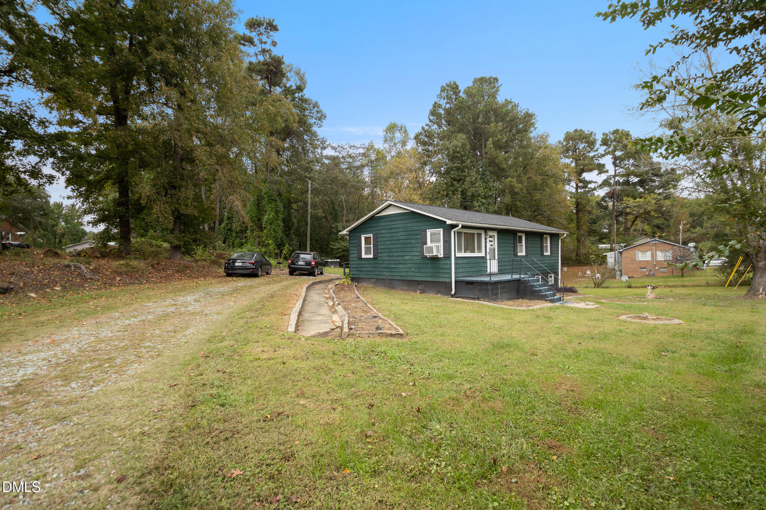 811 Jones Lester Road Roxboro, NC 27574 - Photo 26 of 27 a front view of house with yard patio and tree in the background