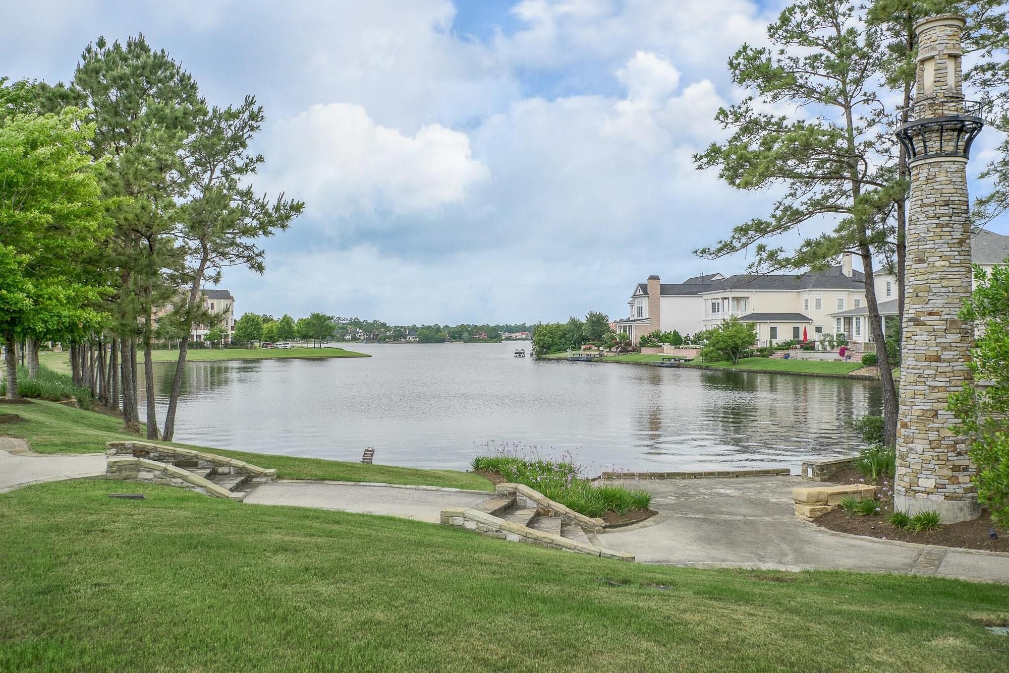 122 Gateway Park Place Spring, TX 77380 - Photo 41 of 44 Serene lakefront setting with winding paved paths, manicured green space, and expansive water views.