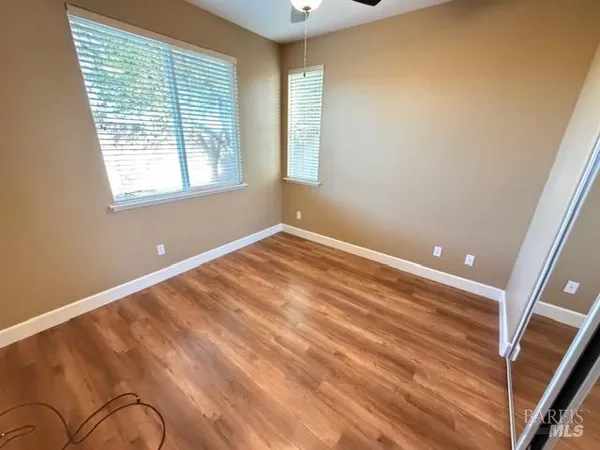 a bathroom with a granite countertop toilet sink and mirror