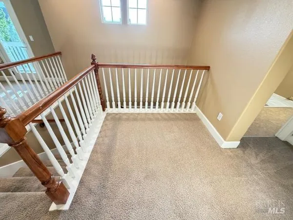 a en suite bathroom with a double vanity sink and a mirror