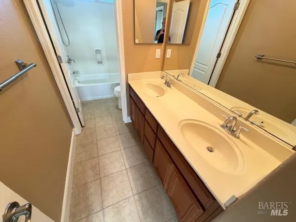 a view of a balcony with wooden chairs