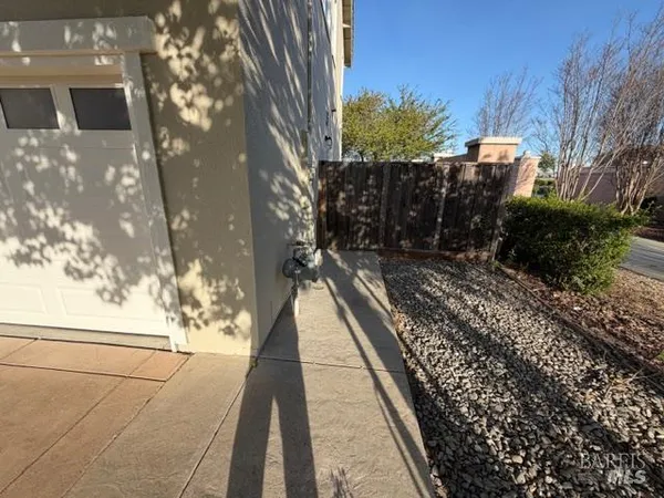 a view of a porch with a table and chairs