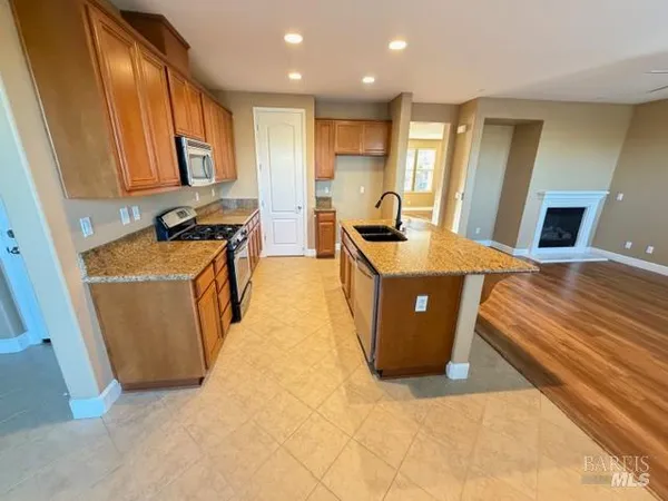 a kitchen with granite countertop sink and cabinets