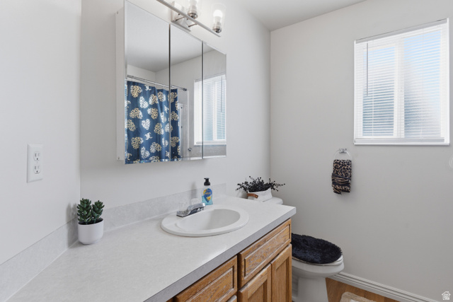 134 West 475 South Ogden, UT 84404 - Photo 16 of 27 Bathroom with vanity, curtained shower, and light wood-style flooring