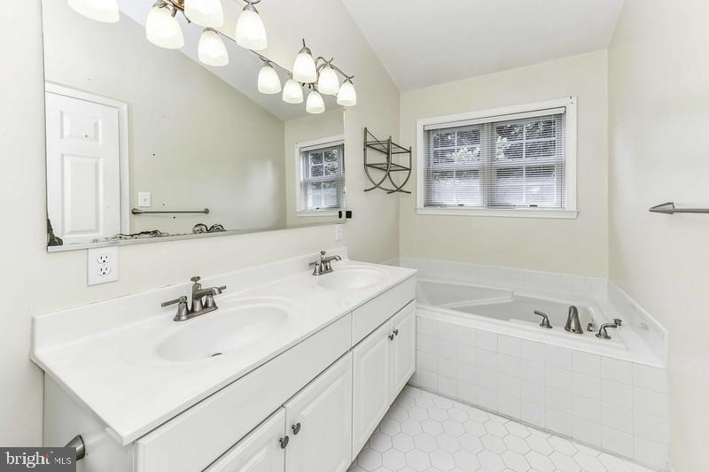2 Parker Farm Court Silver Spring, MD 20906 - Photo 30 of 34 a bathroom with a bathtub a sink and mirror