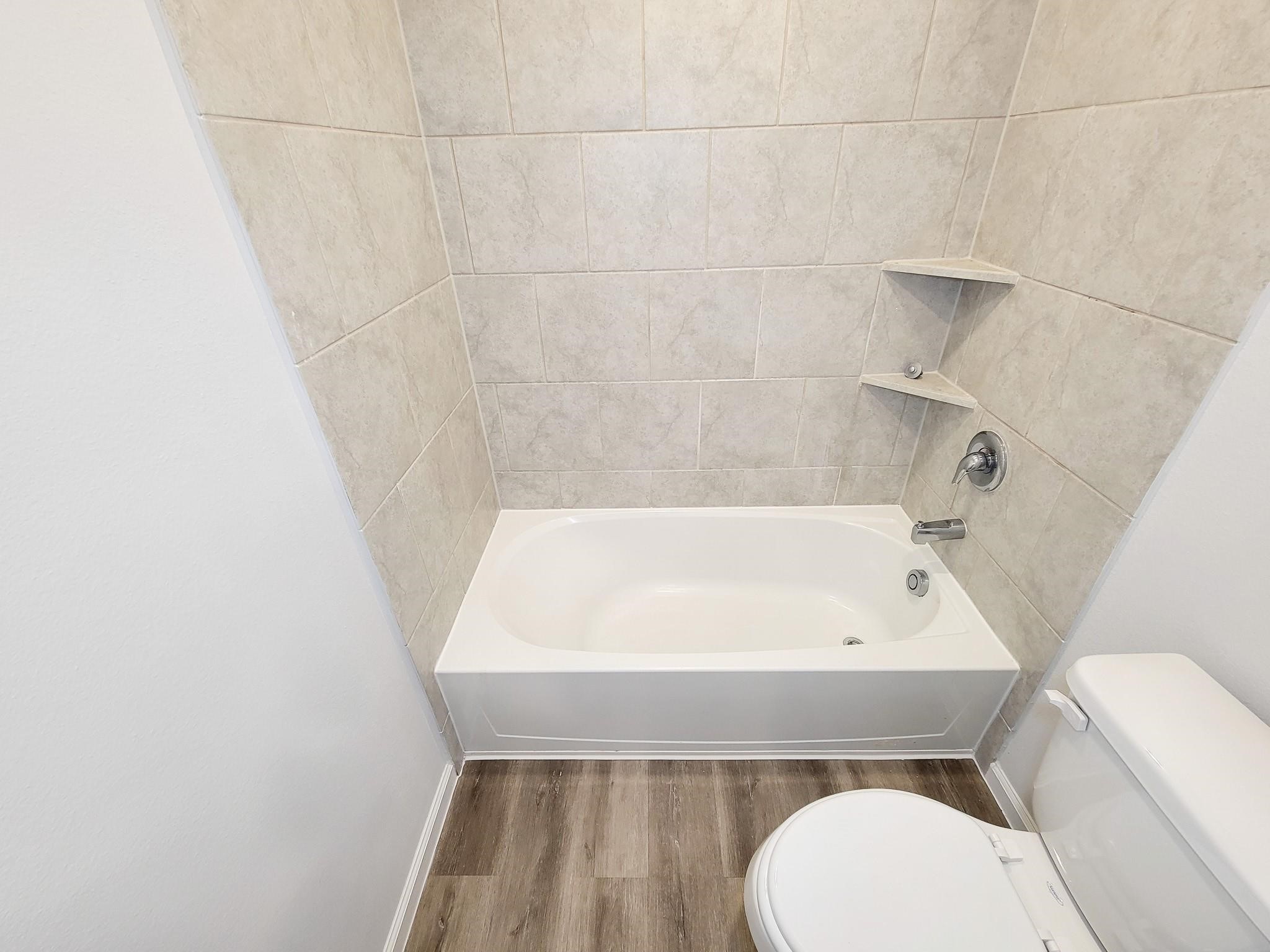 94 Valiant Ridge Trail Magnolia, TX 77354 - Photo 14 of 45 a bathroom with a sink a toilet and bathtub