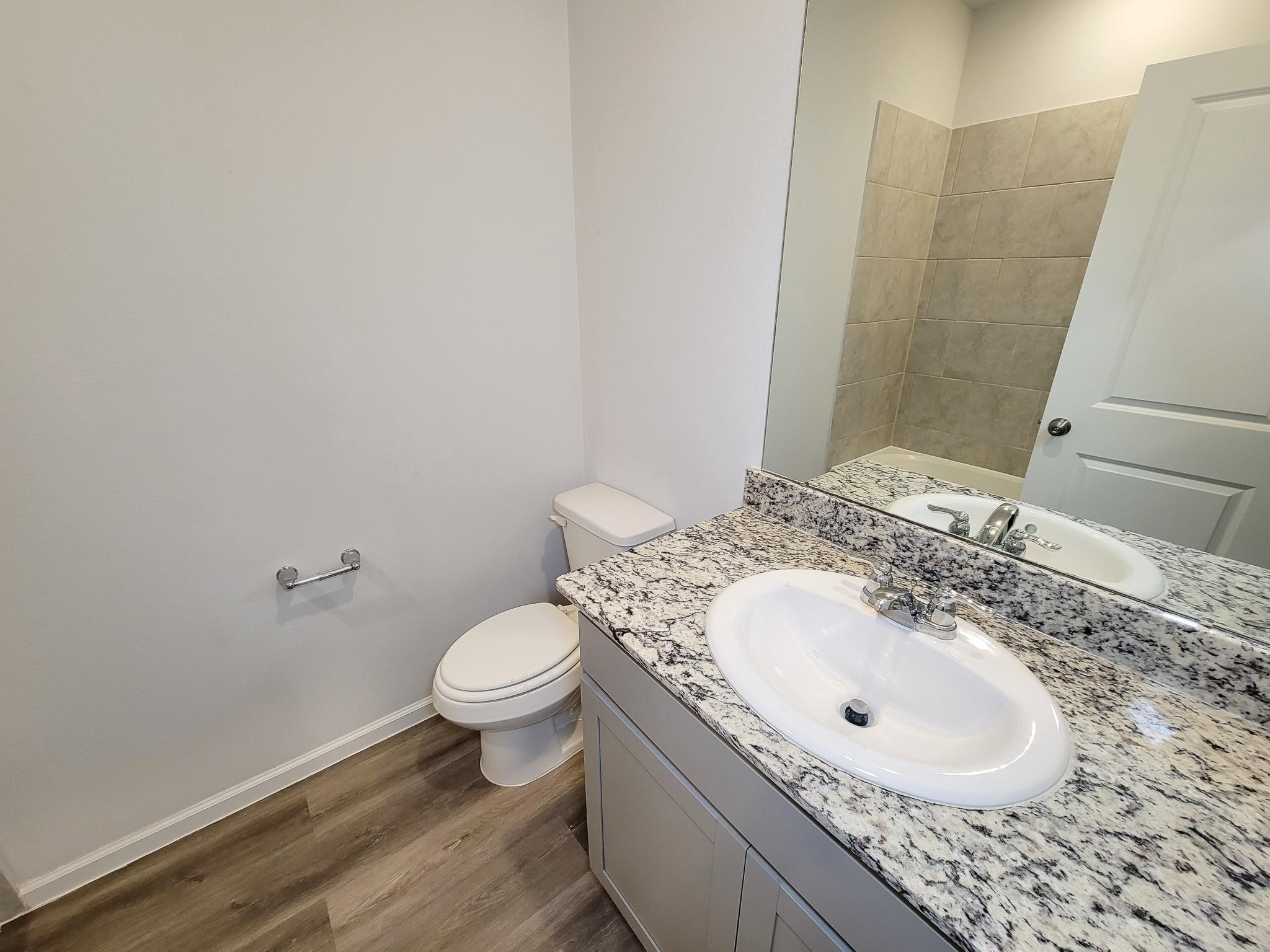 94 Valiant Ridge Trail Magnolia, TX 77354 - Photo 15 of 45 a bathroom with a sink a toilet and a mirror