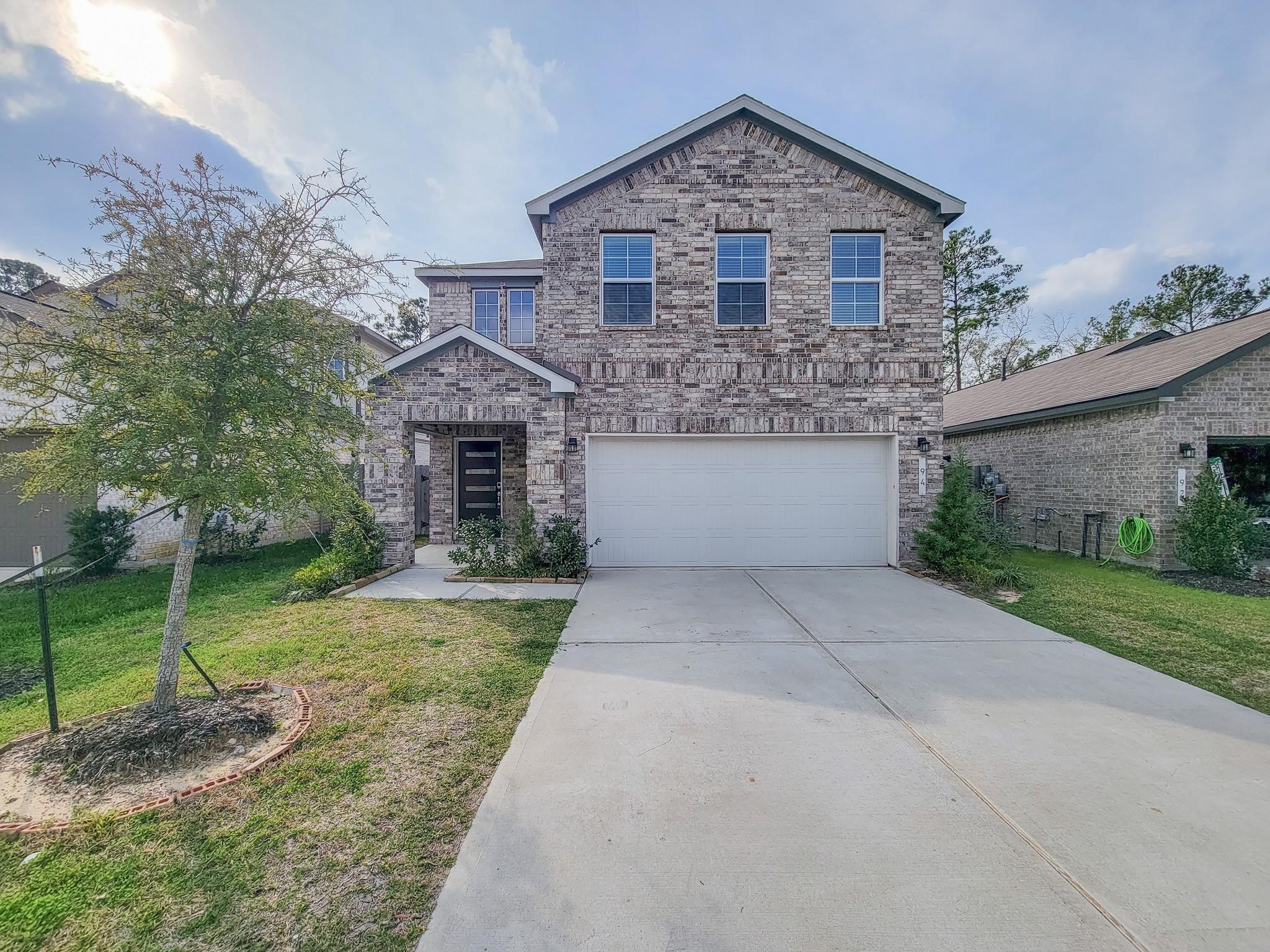 94 Valiant Ridge Trail Magnolia, TX 77354 - Photo 2 of 45 a front view of a house with a yard