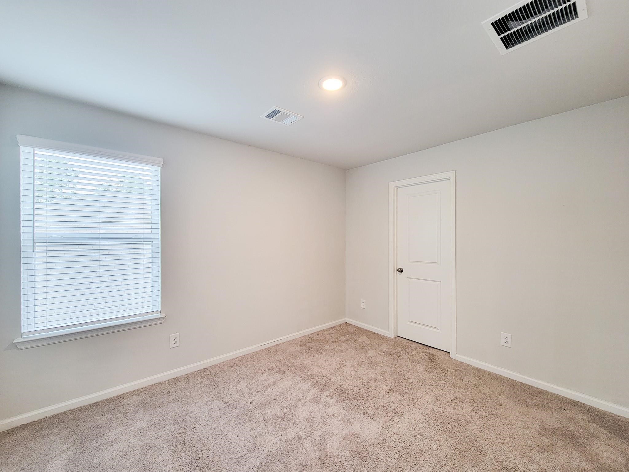 94 Valiant Ridge Trail Magnolia, TX 77354 - Photo 27 of 45 an empty room with windows