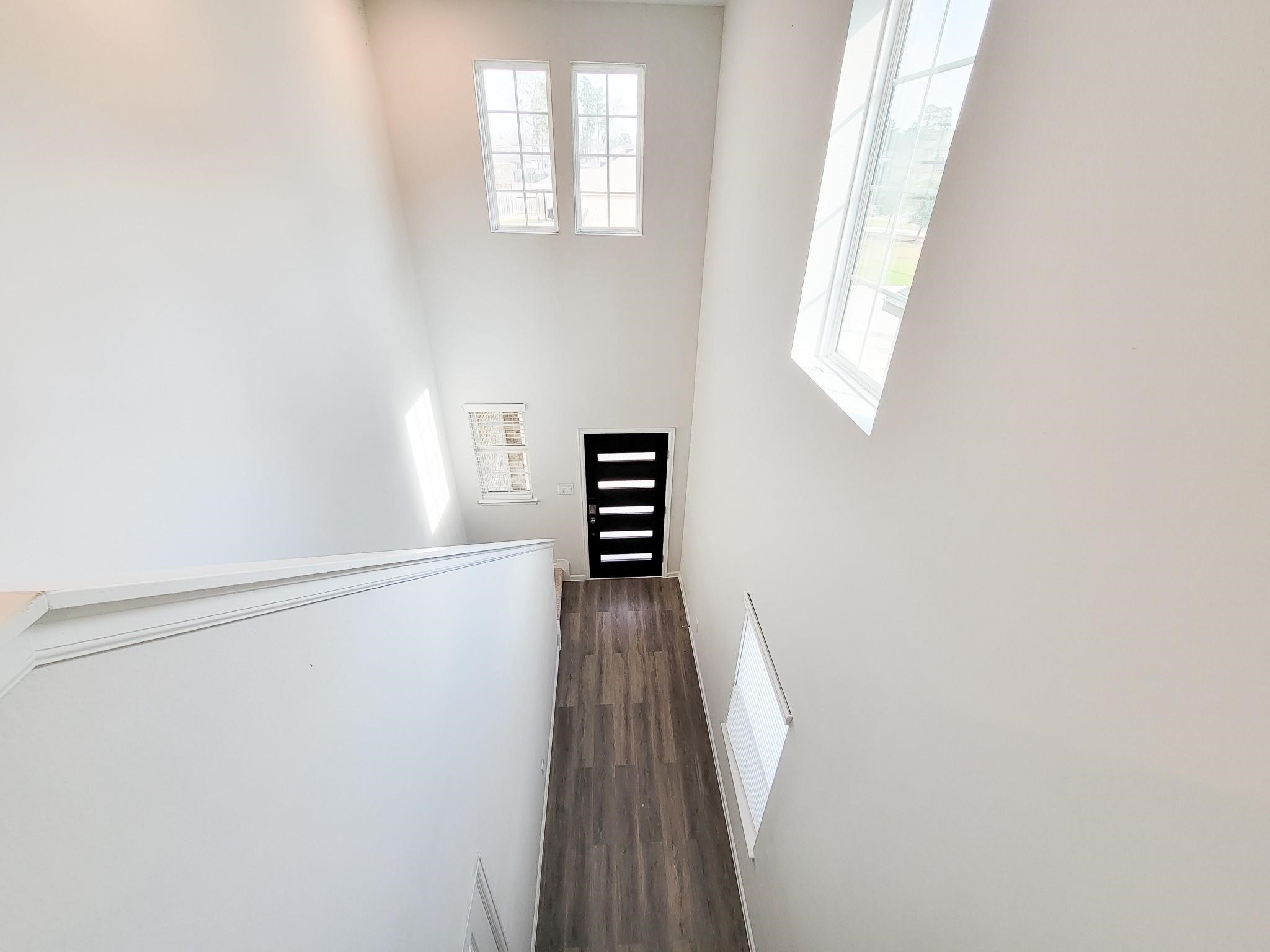 94 Valiant Ridge Trail Magnolia, TX 77354 - Photo 9 of 45 a view of a hallway with wooden floor and staircase