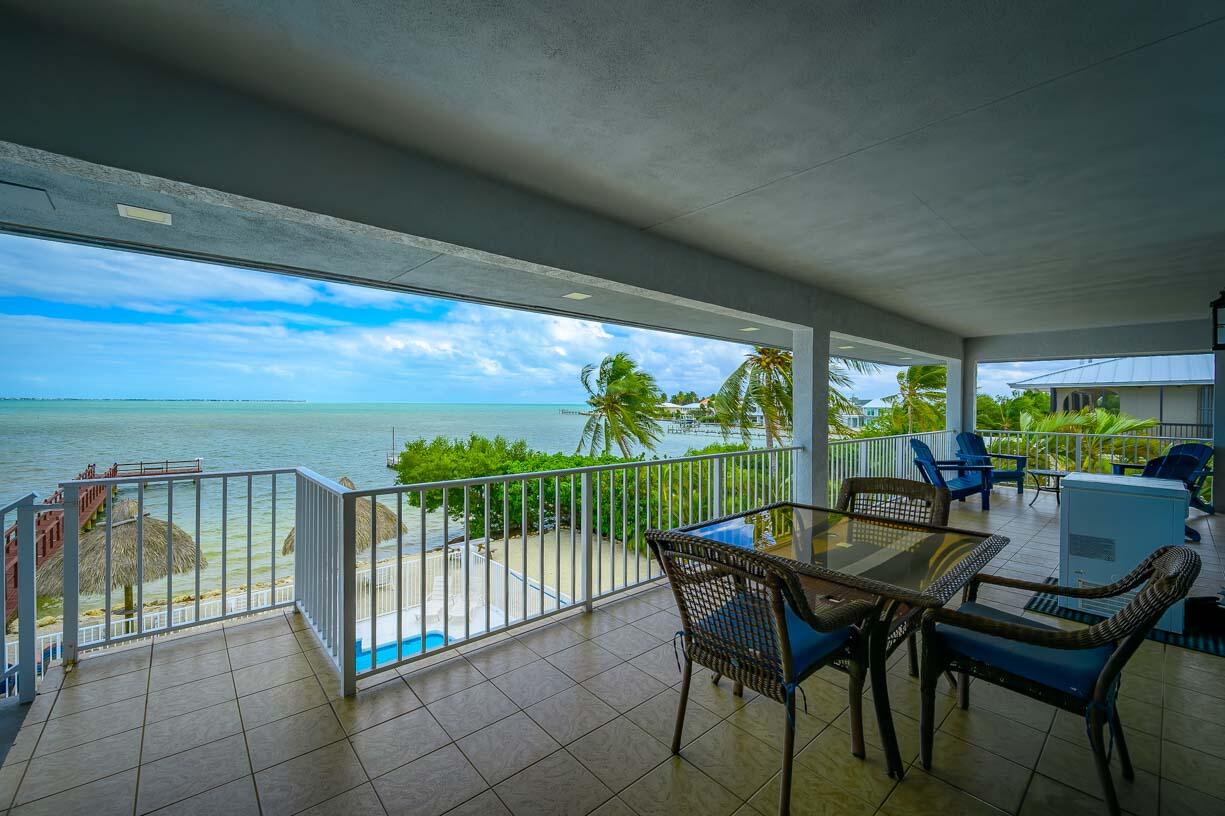 82 Tingler Lane Marathon, FL 33050 - Photo 31 of 54 a view of a patio with a table chairs and a backyard