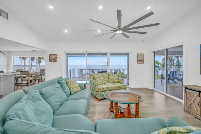 a living room with furniture a rug and a chandelier