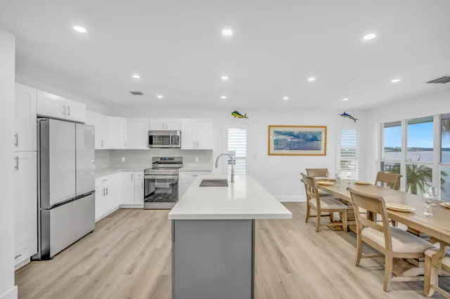 a large kitchen with a table and chairs in it