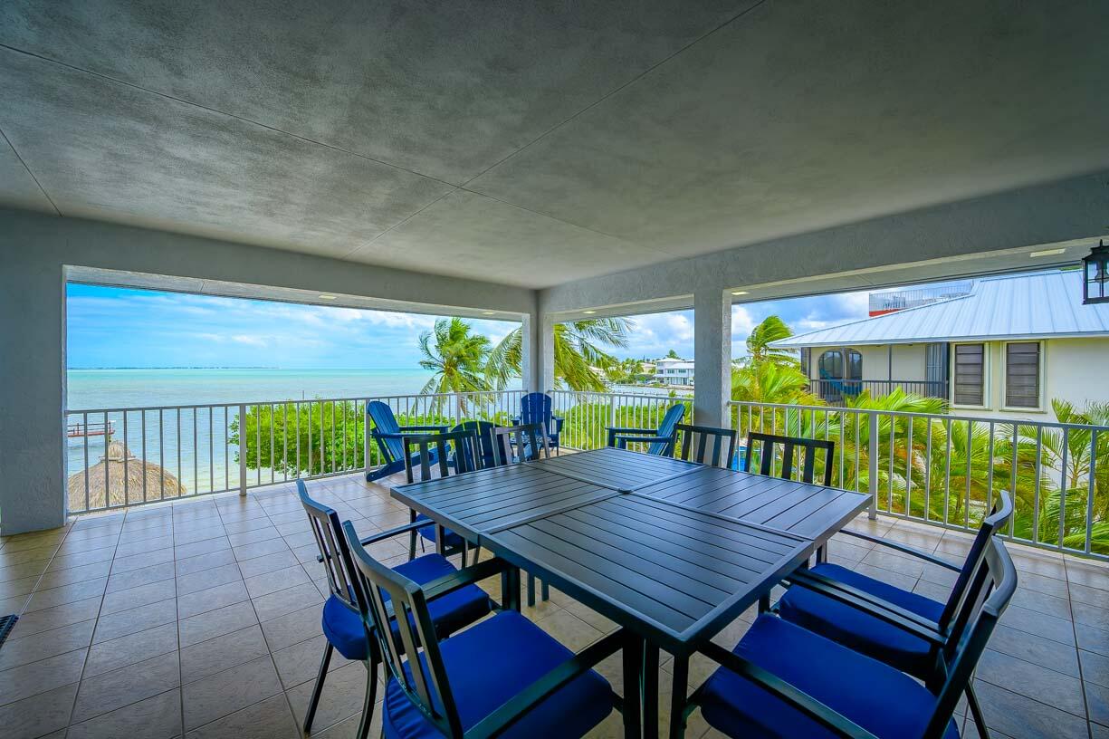 82 Tingler Lane Marathon, FL 33050 - Photo 8 of 54 a view of a dining table and chairs in patio of the balcony