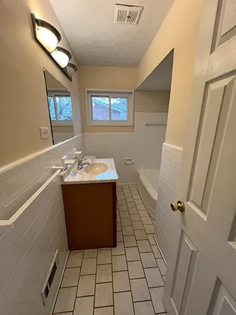 a bathroom with a sink a vanity and a mirror