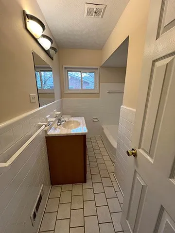 a bathroom with a sink a vanity and a mirror