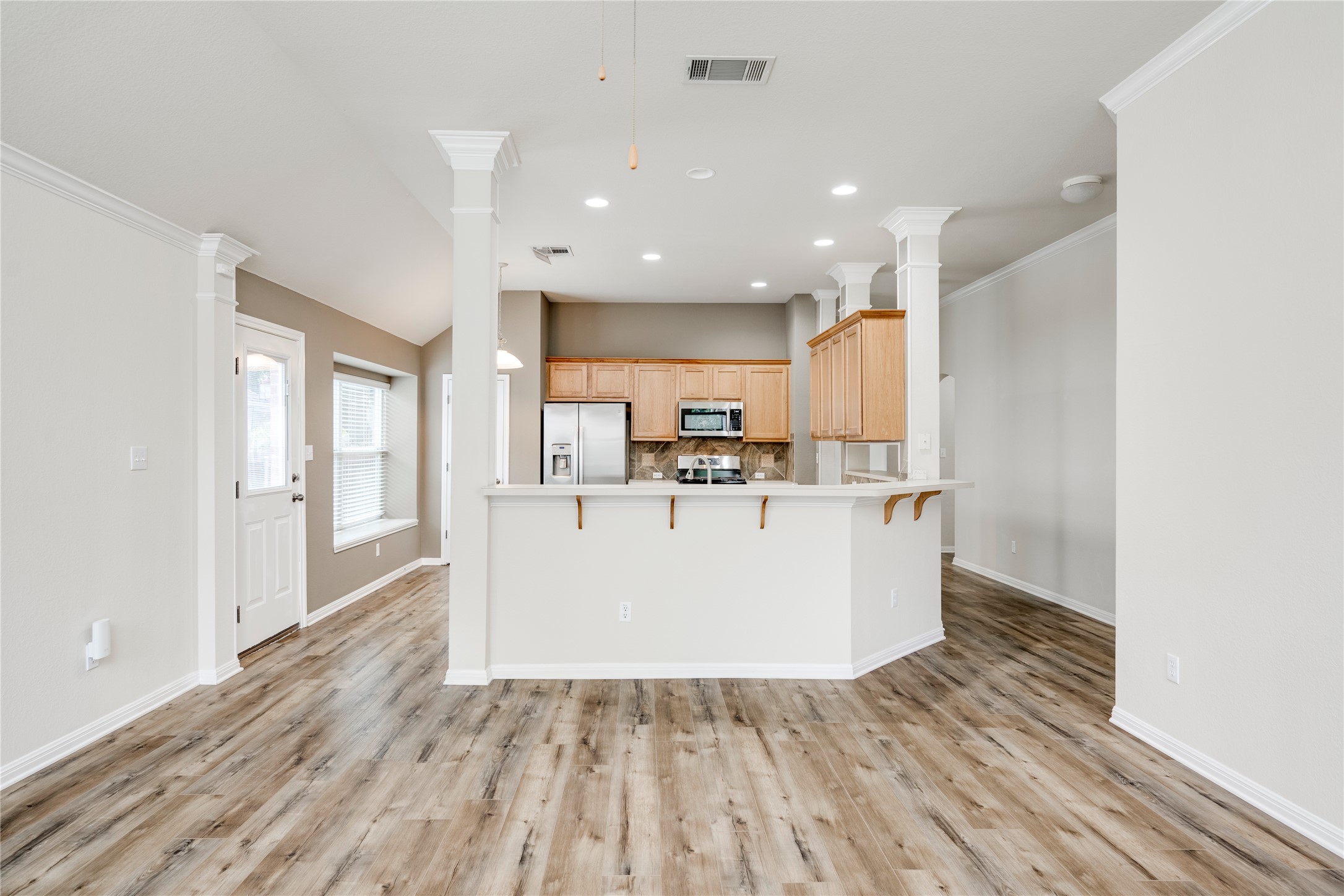 1813 Nelson Ranch Loop Cedar Park, TX 78613 - Photo 15 of 39 An open-concept living area flows seamlessly into the kitchen, showcasing practical design and durable flooring.