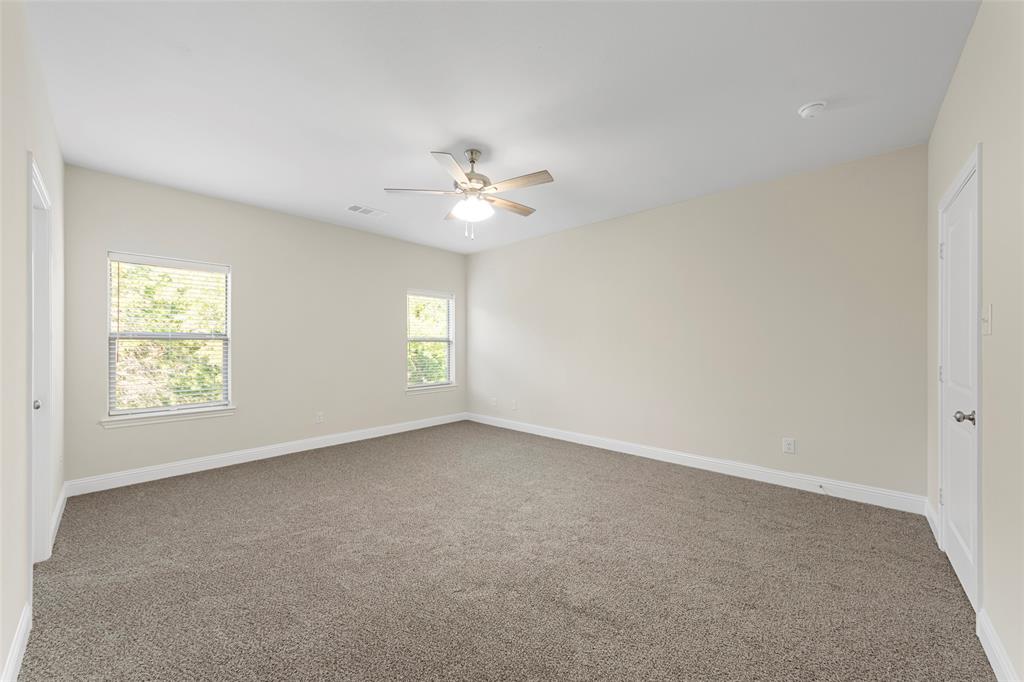 6309 Manson Court Dallas, TX 75227 - Photo 10 of 18 an empty room with windows and ceiling fan