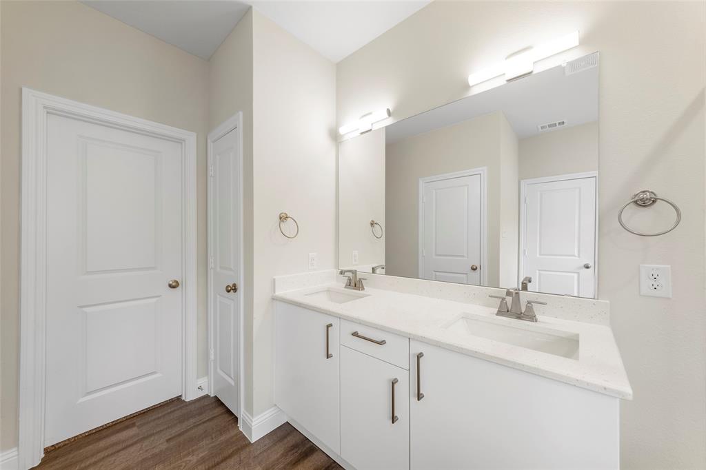 6309 Manson Court Dallas, TX 75227 - Photo 12 of 18 a bathroom with a sink double vanity and a mirror