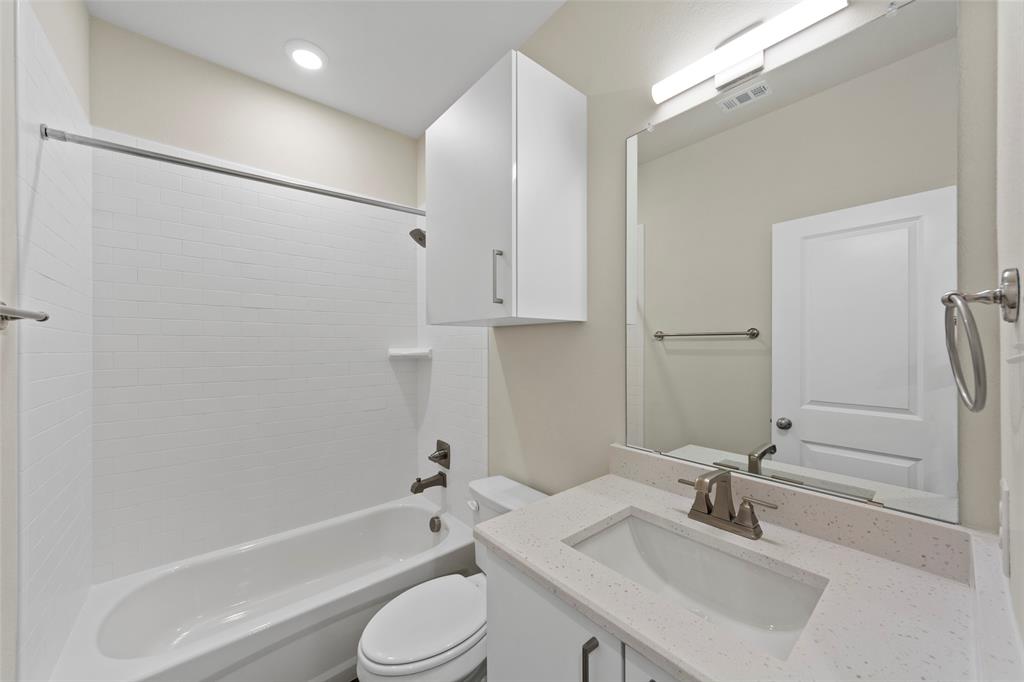 6309 Manson Court Dallas, TX 75227 - Photo 15 of 18 a bathroom with a sink toilet and shower