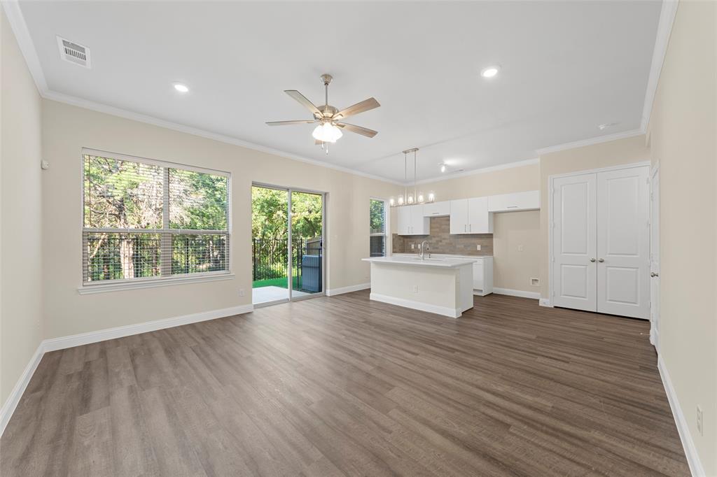 6309 Manson Court Dallas, TX 75227 - Photo 6 of 18 a view of a kitchen with wooden floor and a ceiling fan