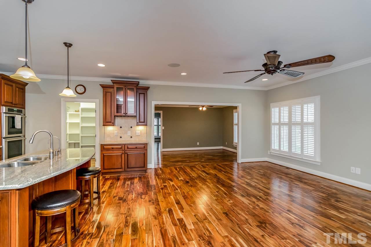 4201 Frost Court Raleigh, NC 27609 - Photo 12 of 25 a view of kitchen and dining room with wooden floor