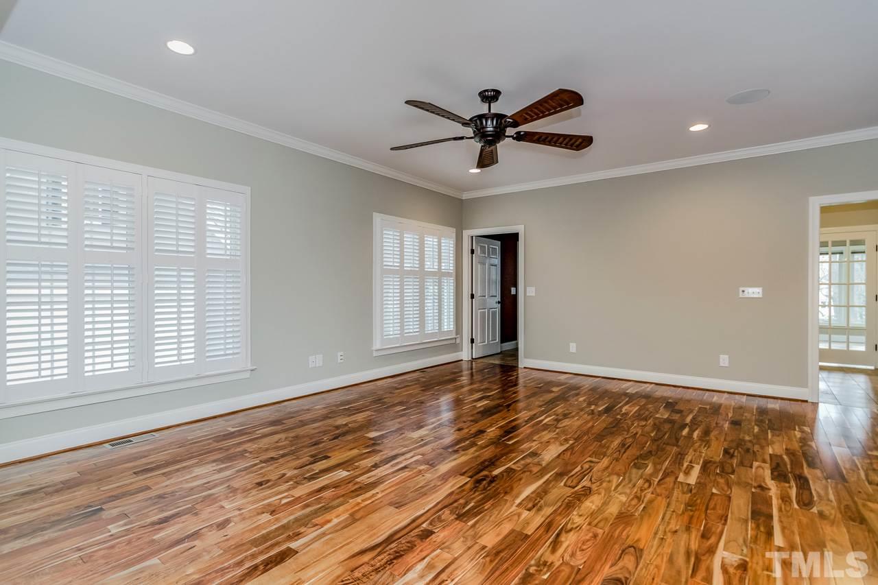 4201 Frost Court Raleigh, NC 27609 - Photo 13 of 25 a view of empty room with wooden floor and fan