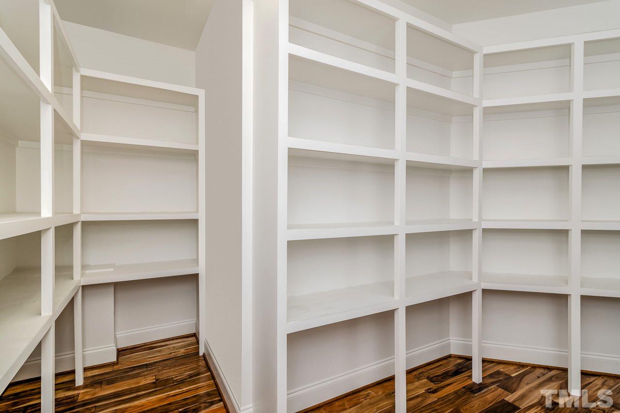 4201 Frost Court Raleigh, NC 27609 - Photo 14 of 25 a view of walk in closet with empty racks