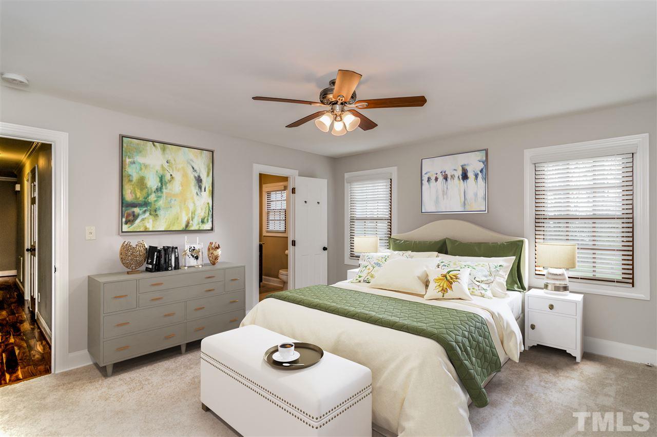 4201 Frost Court Raleigh, NC 27609 - Photo 16 of 25 a bedroom with a bed and a chandelier