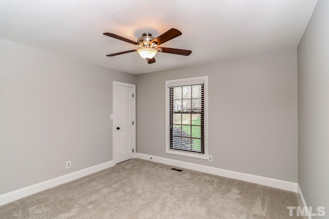 4201 Frost Court Raleigh, NC 27609 - Photo 22 of 25 an empty room with windows and fan
