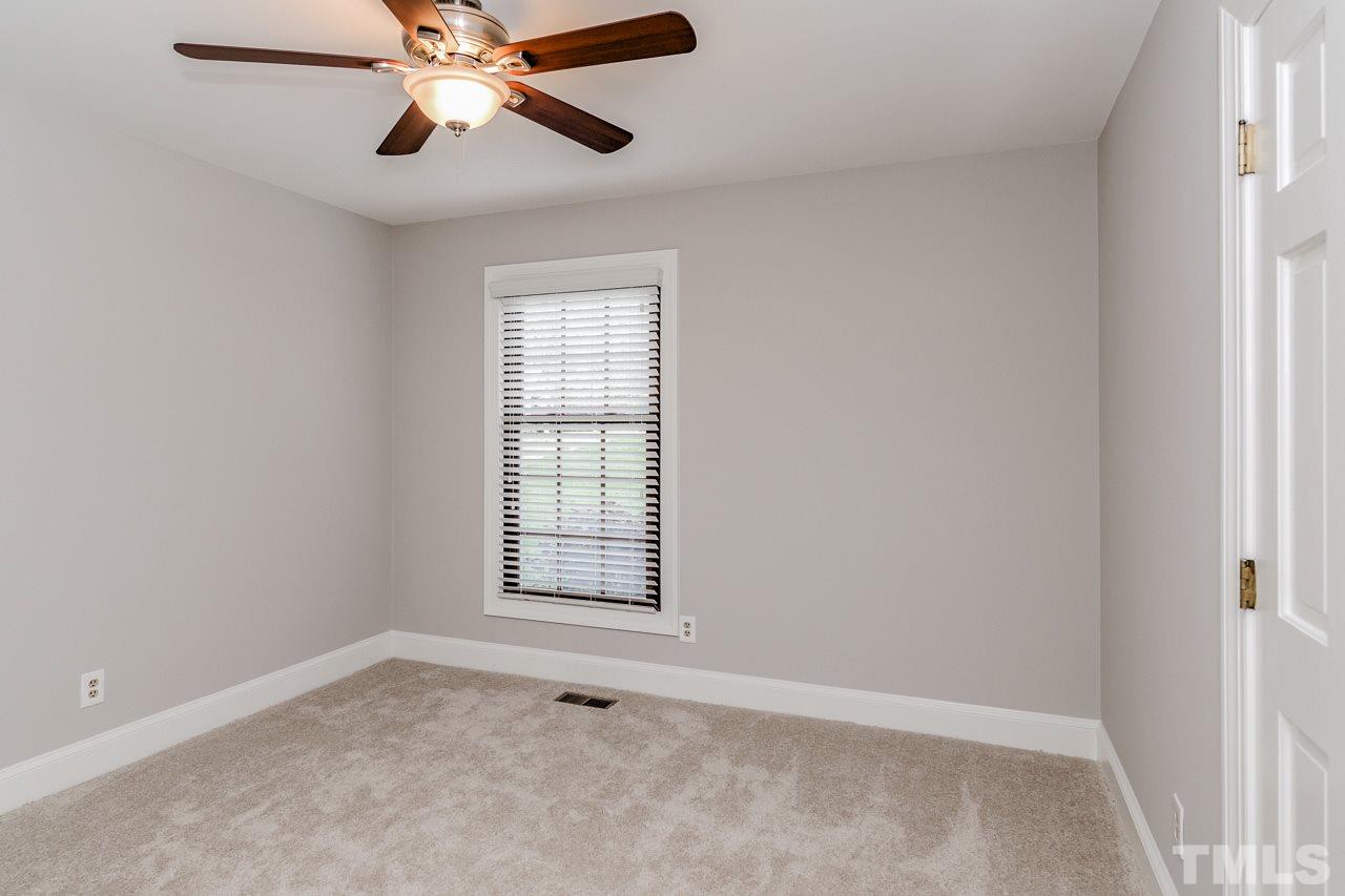 4201 Frost Court Raleigh, NC 27609 - Photo 23 of 25 an empty room with windows and fan