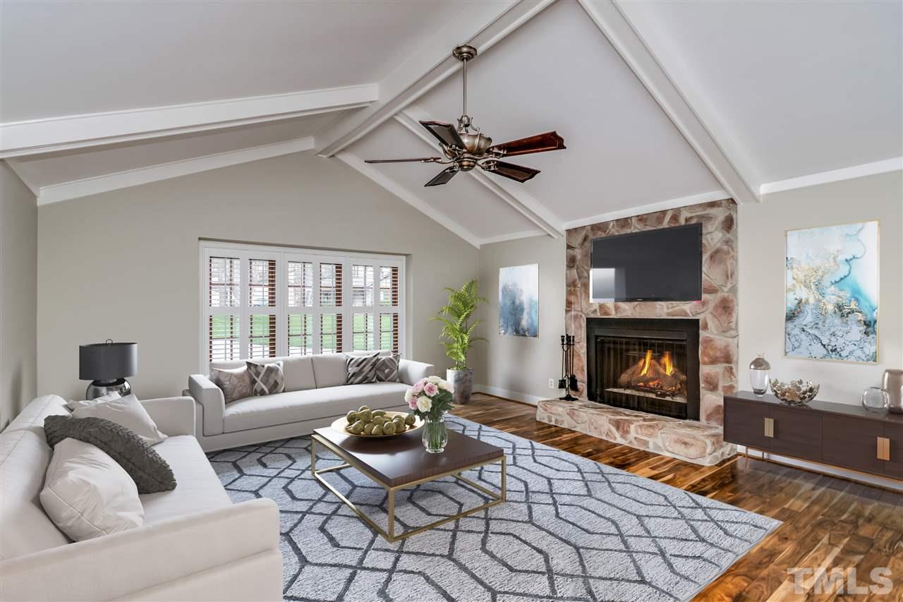 4201 Frost Court Raleigh, NC 27609 - Photo 7 of 25 a living room with furniture and a fireplace