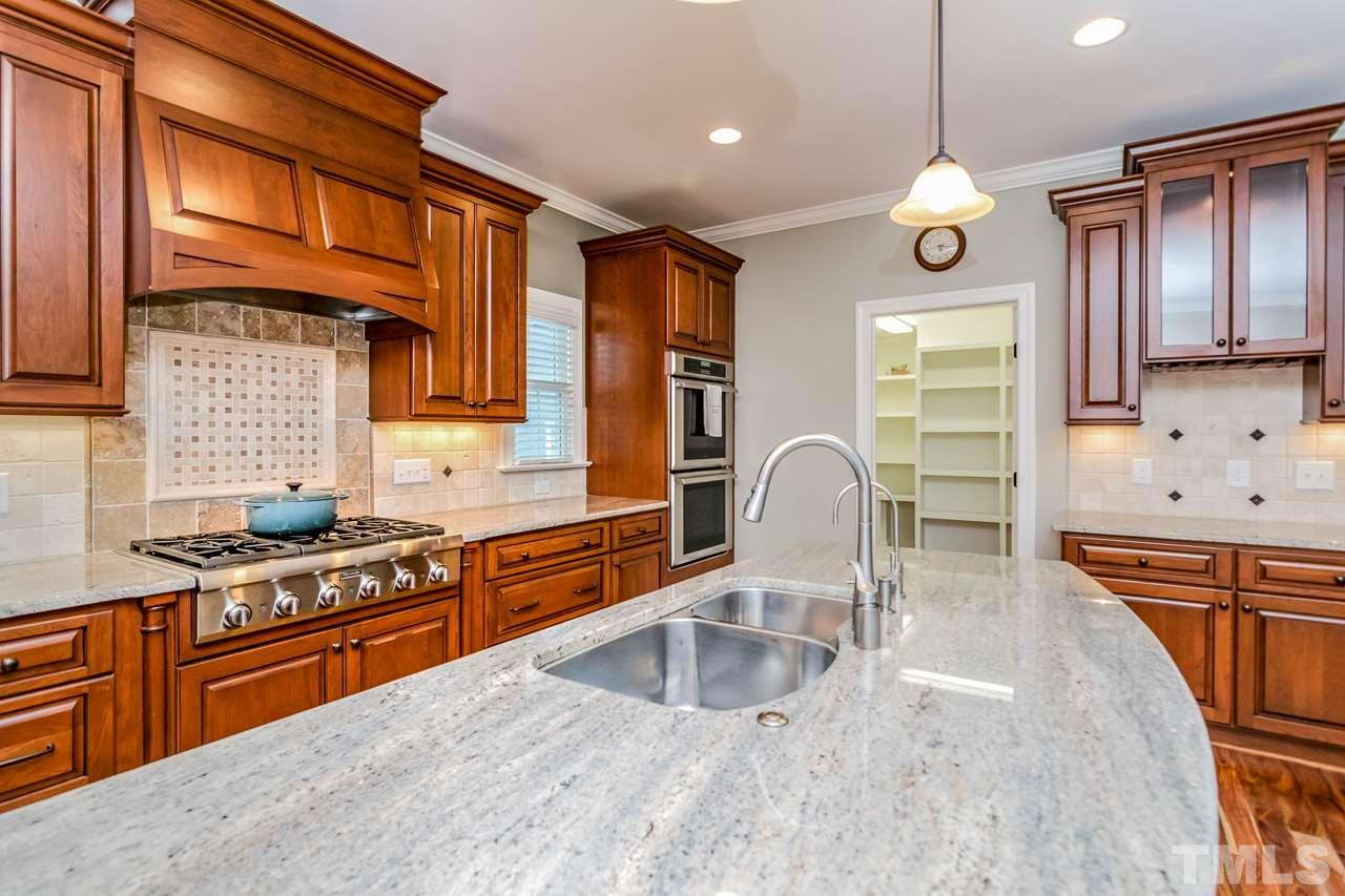 4201 Frost Court Raleigh, NC 27609 - Photo 9 of 25 a kitchen with stainless steel appliances granite countertop a stove a sink and a microwave