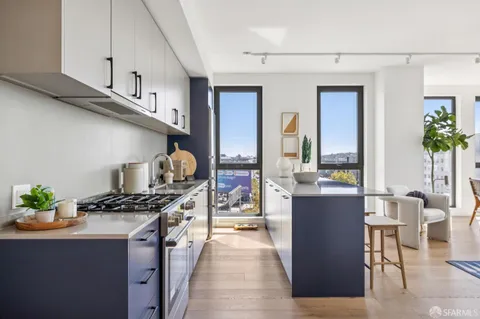 a kitchen with stainless steel appliances granite countertop a stove and a dining table