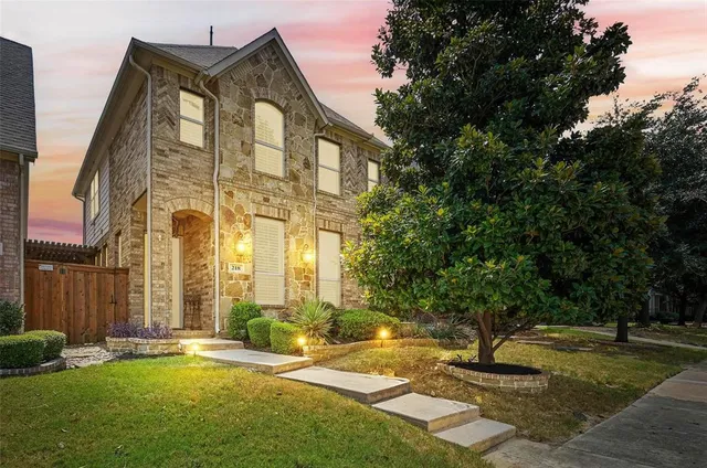 a large brick building with a yard in front of it