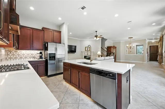 a kitchen with a sink appliances and cabinets