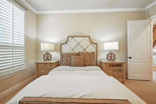 a bedroom with a bed and a flat tv screen on dresser