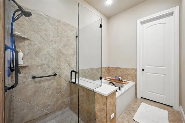 a bathroom with a tub a sink and a shower