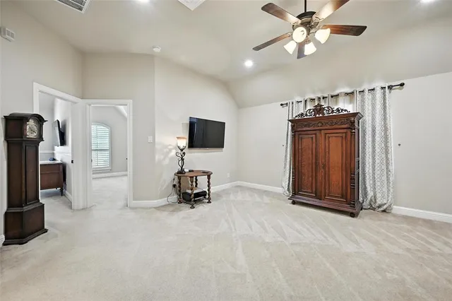 an empty room with windows and ceiling fan
