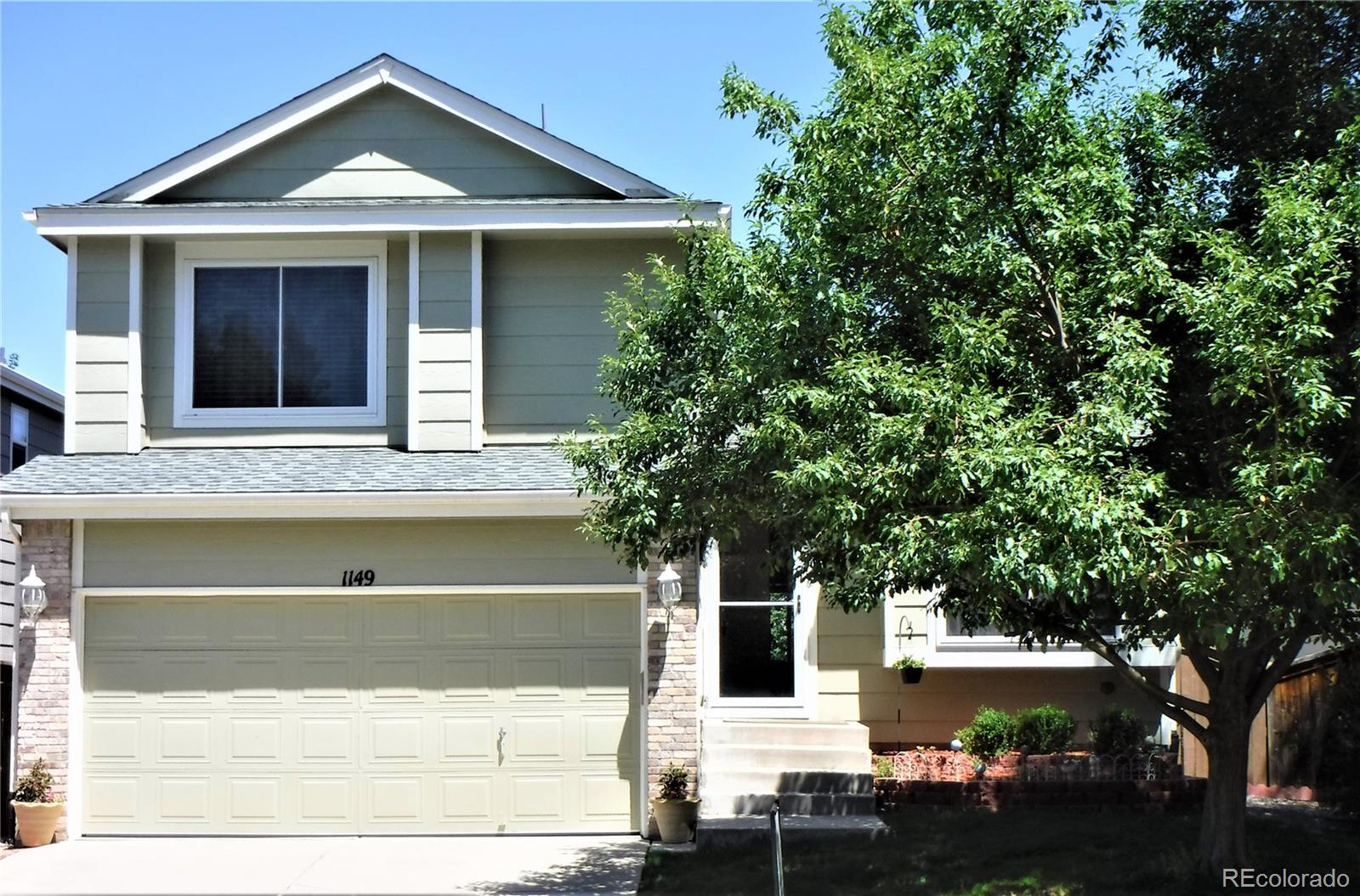 1149 Timbervale Trail Highlands Ranch, CO 80129 - Photo 1 of 32 a front view of a house with garden