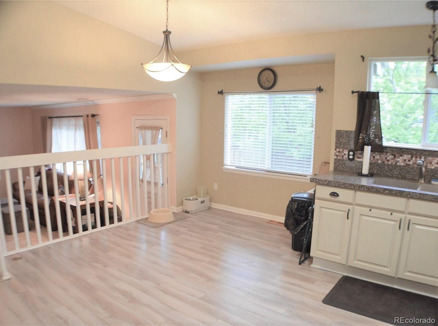 1149 Timbervale Trail Highlands Ranch, CO 80129 - Photo 13 of 32 a view of an empty room with a window and wooden floor
