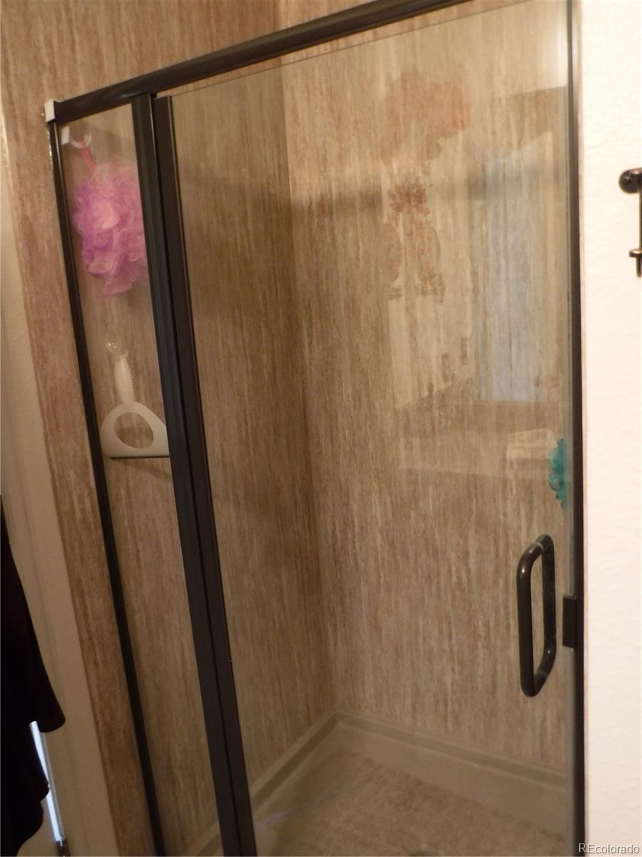 1149 Timbervale Trail Highlands Ranch, CO 80129 - Photo 24 of 32 a bathroom with a shower and a mirror