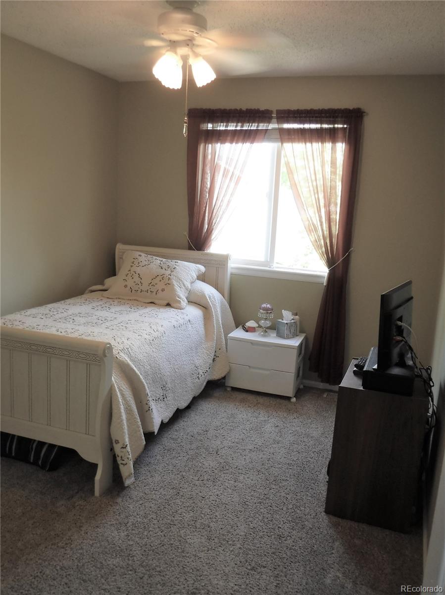 1149 Timbervale Trail Highlands Ranch, CO 80129 - Photo 25 of 32 a bedroom with a bed and a window