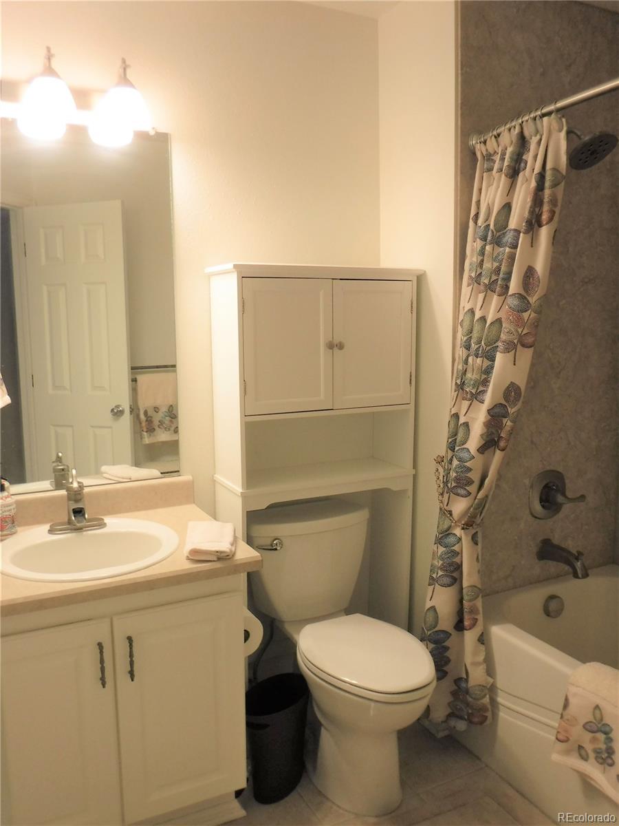 1149 Timbervale Trail Highlands Ranch, CO 80129 - Photo 27 of 32 a bathroom with a sink toilet and shower