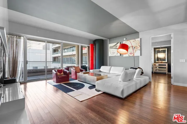 a living room with furniture flat screen tv and wooden floor