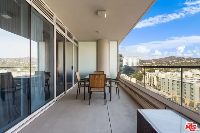 a bathroom with a tub and balcony view