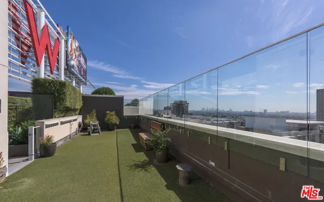 a view of outdoor space with tub and windows