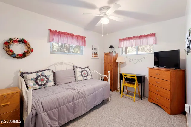 a bedroom with a bed and flat screen tv
